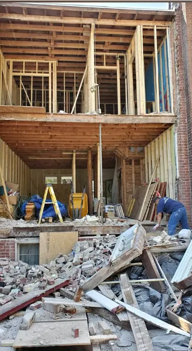 Crew member working in a two-storey opening where the rear wall and floor were removed